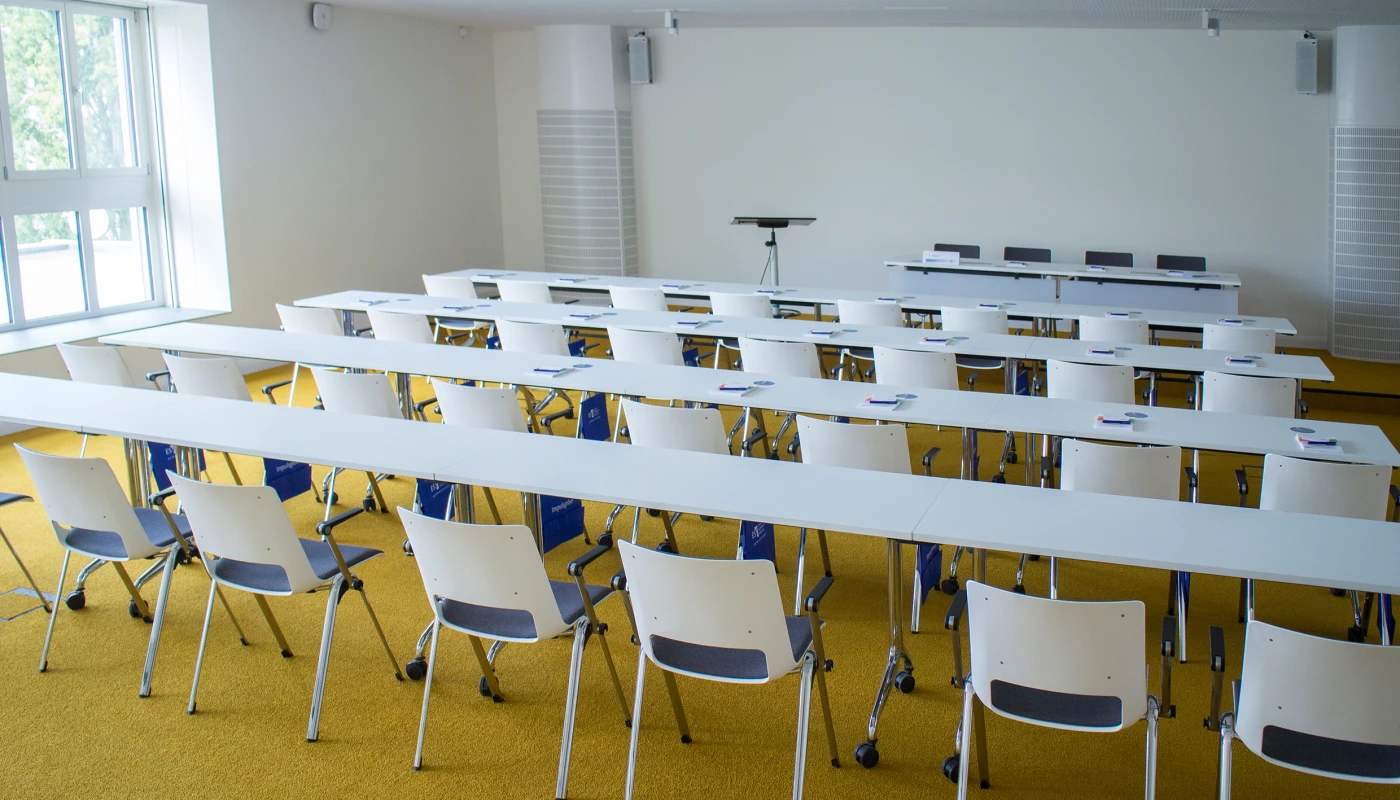 Seminarraum mit parlamentarischer Bestuhlung und breiten Tischen