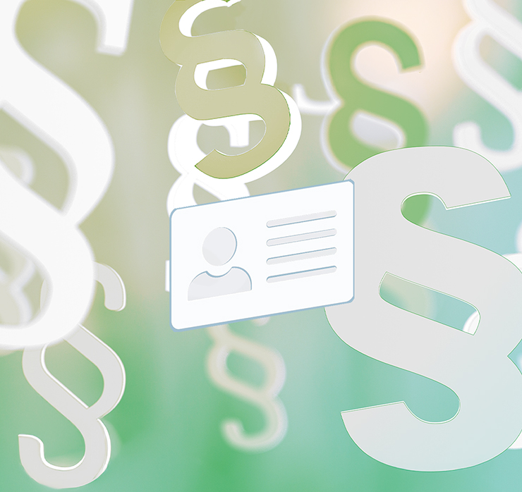 Paragraphenzeichen und Ausweiskarte als Symbol für das Arbeitsrecht